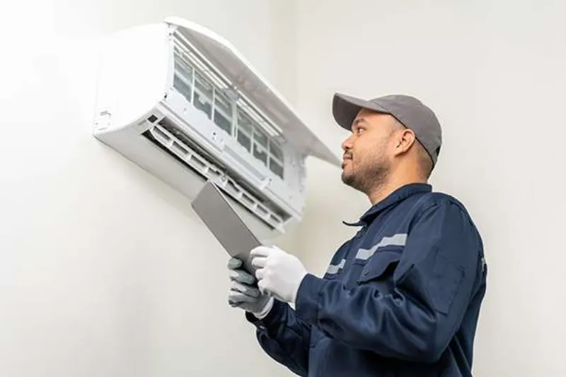 Technician servicing a ductless mini split unit