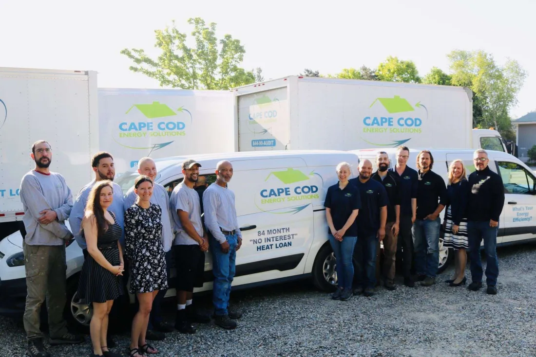 The High Efficiency Energy Solutions crew standing with company vans