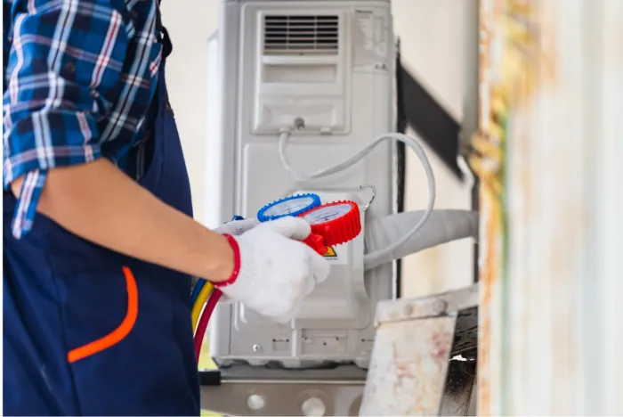 Technician checking air flow with a handheld diagnostic tool